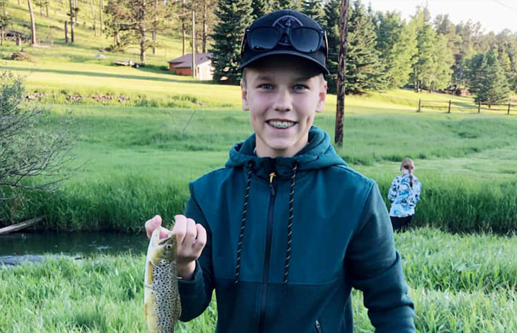 Boy holding a fish in the Black Hills SD
